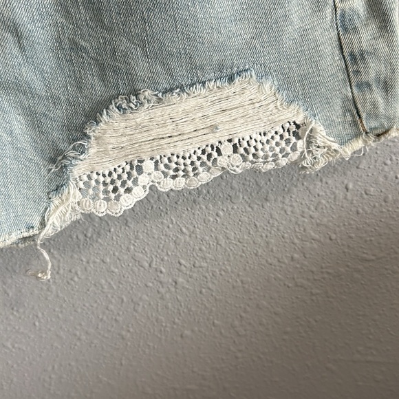 Light wash distressed denim shorts with lace detail. Size 4. - Picture 3 of 5